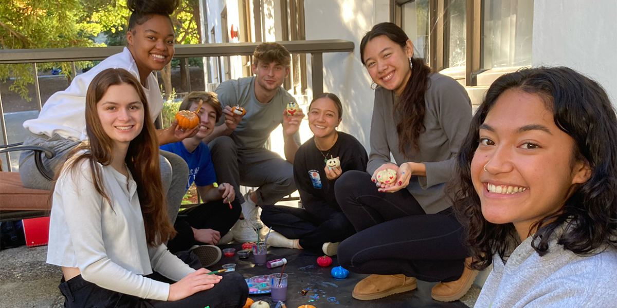 Honors students painting on the Aquinas terrace
