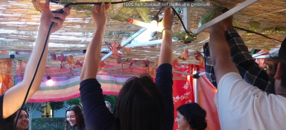 Image of students holding up a colorful tent