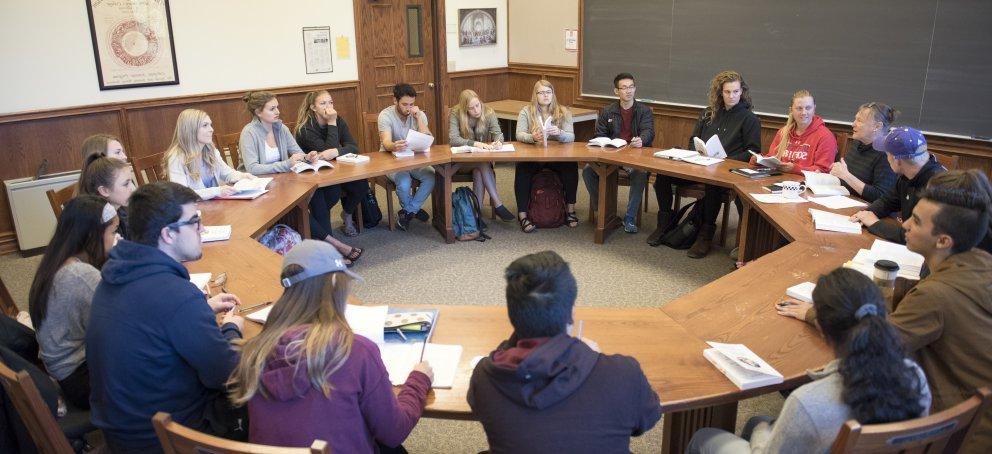 Students in a seminar class, sitting around a circular table
